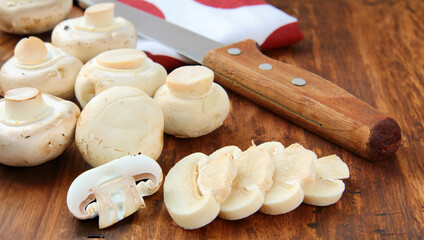 fresh champignon mushrooms on a wooden board