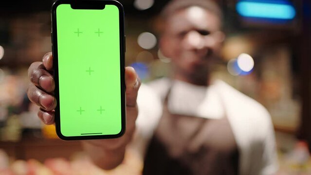 Smartphone with chromakey screen held by African American man