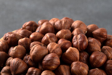 View of a bowl full of hazelnuts on a black background,closeup
