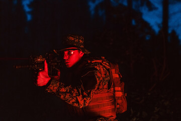 Fototapeta na wymiar Soldiers squad in action on night mission using laser sight beam lights military team concept