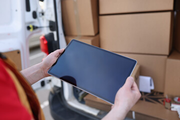 Courier looking for address on digital tablet. Home delivery service and delivery concept