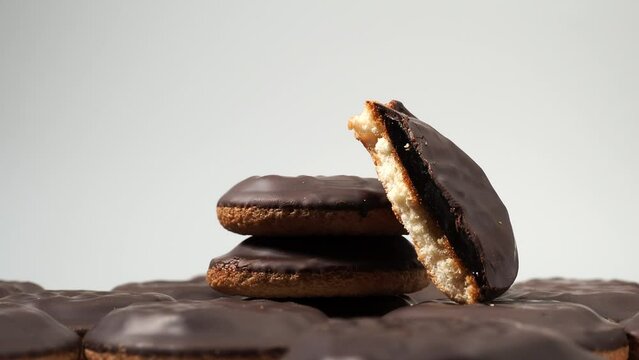 Rotating cookies with dark chocolate and orange marmalade. Cookies on a white background.