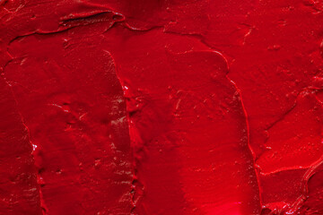 Red lipstick background texture smudged. Close up.