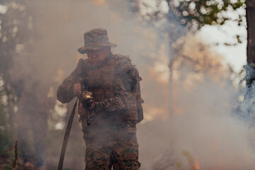 A soldier fights in a warforest area surrounded by fire