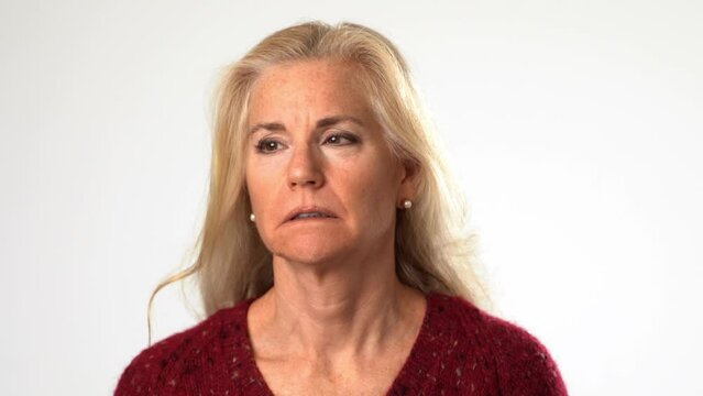 Closeup of angry, scared, confused senior mature middle age woman put hands out ask why me, isolated on white background studio. People lifestyle emotions concept. 