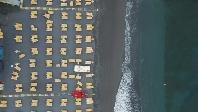 Aerial view of a small beach with parasols along the Mediterranean Sea coastline in Maratea, Potenza, Basilicata, Italy.