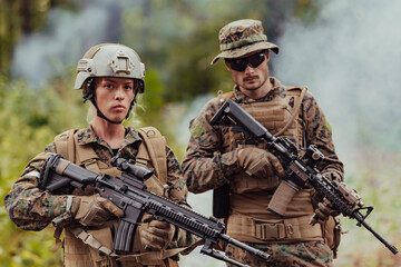 Fototapeta premium Modern Warfare Soldiers Squad Running in Tactical Battle Formation Woman as a Team Leader
