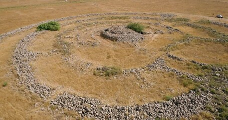 Aerial view of ancient megalithic monument site in the shape of 3 concentric stone circles, Rujum Al-Hiri, Golan Heights, Israel.