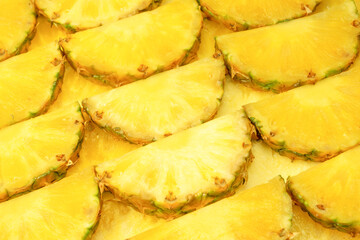 Pineapple juicy yellow slices as a background.