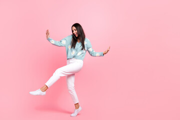 Full length photo of shiny sweet pretty lady wear flower print cardigan walking dancing empty space isolated pink color background