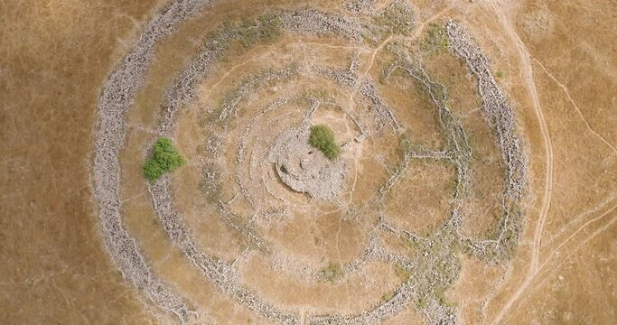 Aerial view of ancient megalithic monument site in the shape of 3 concentric stone circles, Rujum Al-Hiri, Golan Heights, Israel.