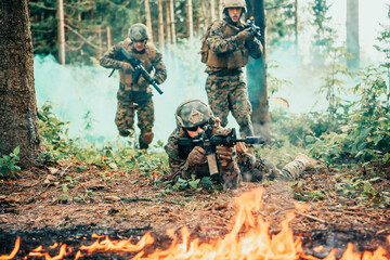 Modern warfare soldiers surrounded by fire fight in dense and dangerous forest areas