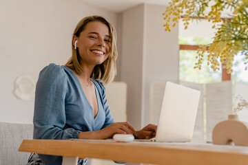 young pretty stylish woman working remote at home at table workplace, student education