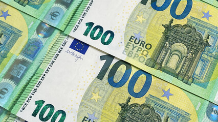 Fototapeta na wymiar 100 euros. Financial business background concept. Close-up of one hundred euro bills. Green background of money. European currency. Cash banknotes.