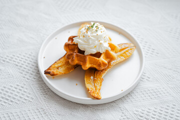 Waffels with banana and whipped cream