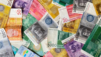 Kyrgyz national currency. Beautiful colored background of money. Kyrgyz banknotes of different denominations. Cash banknotes of Kyrgyzstan.