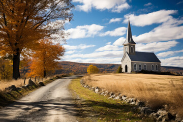 A small white church with a steeple in a rural setting. The church is located on a dirt road with a stone wall on the right side and is surrounded by a field of tall grass - obrazy, fototapety, plakaty