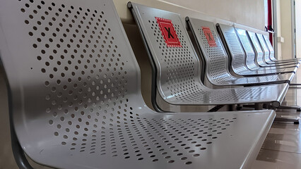 Hospital hallway with rows of empty benches