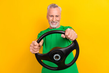 Portrait of positive funky person toothy smile arms hold steering wheel isolated on bright yellow color background