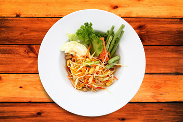 Spicy papaya salad in white plate