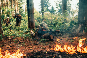 Modern warfare soldiers surrounded by fire fight in dense and dangerous forest areas