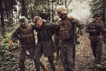 Fototapeta premium Soldiers squad was capture alive terrorist and interrogation them on them on special tactics violent way