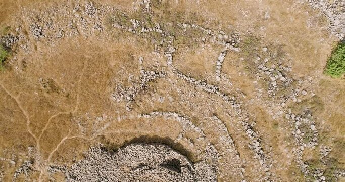 Aerial view of ancient megalithic monument site in the shape of 3 concentric stone circles, Rujum Al-Hiri, Golan Heights, Israel.