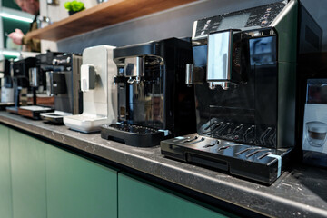 Row of many coffee machines on sale in store