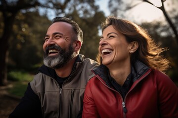 portrait of couple in the park laughing - enjoying each other 