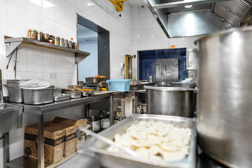 Stainless steel food trays on counter in professional kitchen