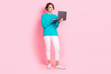 Full length photo of lovely young lady hold netbook marketer smm manager wear trendy blue garment isolated on pink color background