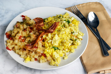 scramble eggs and hash browns top with  bacon