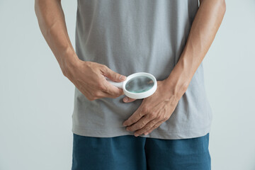 Man hold hand in front of private parts feeling discomfort from disease and inflammation. Venereal,...