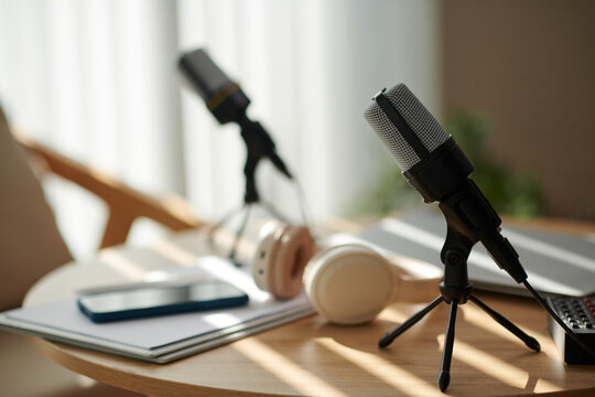 Microphones on table prepared for podcaster and show guest