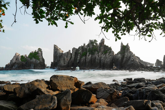 photo of pantai batu layar or pantai gigi hiu at kelumbayan tanggamus lampung, high quality images good for background. long exposure shoot on exotic beach. summer natural rocks corals daylight