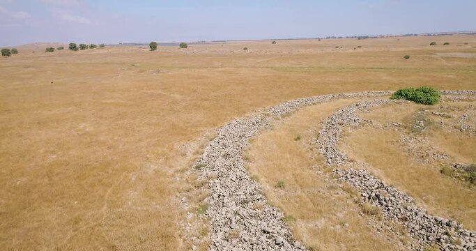 Aerial view of ancient megalithic monument site in the shape of 3 concentric stone circles, Rujum Al-Hiri, Golan Heights, Israel.