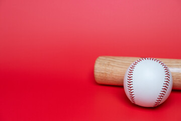 Close up baseball and baseball bat on red table copy space background, sport concept