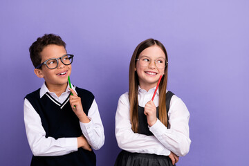 Photo of thoughtful two buddies schoolkids look empty space think over exam test task isolated vivid color background