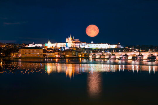 Prague Castle and Charles Bridge, Prague, Czech Republic, Vltava river in foreground with full moon "Elements of this image furnished by NASA"