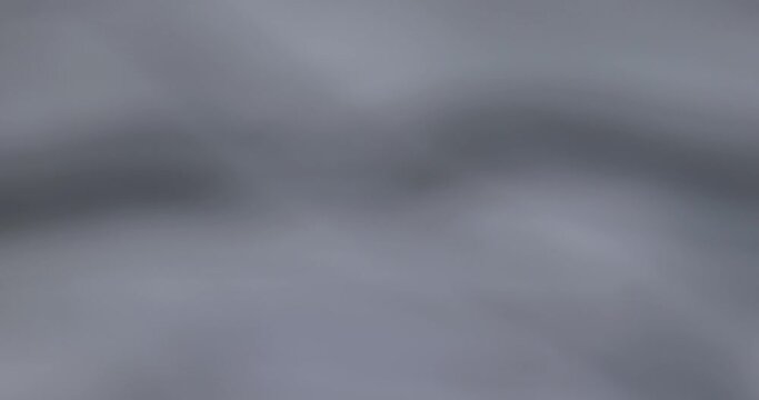 crumpled gray material in close-up, part of the fabric from gray-tinged clothing
