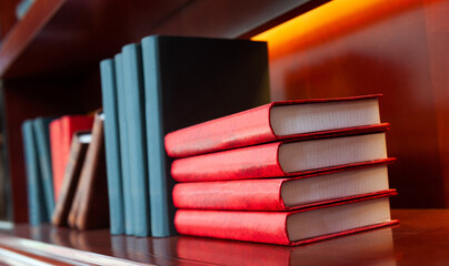 Many old hardcover books on a bookshelf