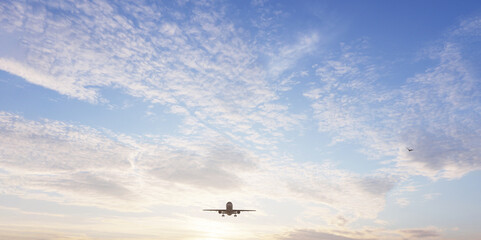 Airplane in the sky at sunset. Air transportation.  Travel. Airplane Takes Off Against the Background of Blue Sky. 