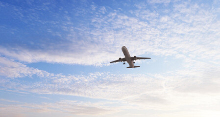 Airplane in the sky at sunset. Air transportation.  Travel. Airplane Takes Off Against the Background of Blue Sky. 