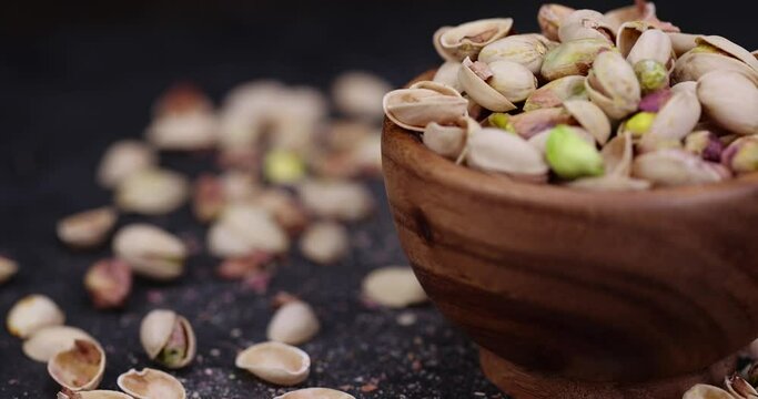 focus on pistachio nuts on the table, a large number of salty and crispy pistachios close-up