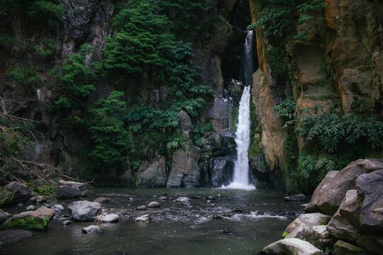 Scenic view of a waterfall in a tropical forest on Azores islands in Portugal