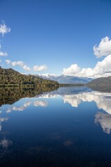 Landscape of the tranquil Lake Mapourika reflecting the majestic mountains in New Zealand
