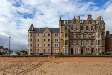 Fototapeta na wymiar Tall old building on the seashore in Portobello, Edinburgh, United Kingdom