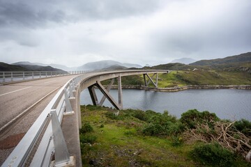 Fototapeta na wymiar Scenic view of the Kylesku Bridge arching over a river in Scotland