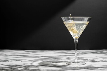 a glass with a yellow drink sitting on top of a counter