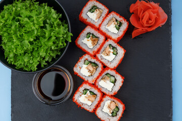 rolls with tereyaki salmon on a blue background for a restaurant menu, studio shooting 5